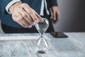 Businessman holding hourglass in hand Royalty Free Stock Photo