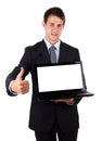 Young businessman holding laptop with thumbs up Royalty Free Stock Photo