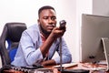 Young businessman holding a phone in the office Royalty Free Stock Photo