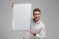 Portrait of young man with clean magnetic Board in his hands isolated on white background