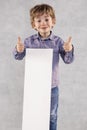 Young businessman holds an advertising space for sale, thumbs up Royalty Free Stock Photo