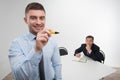 Young businessman holds marker writing, drawing Royalty Free Stock Photo