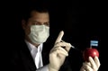 Young businessman injecting chemicals into an apple with Botswanan flag on black background