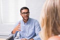 Young businessman interviewing woman