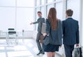 Young businessman inviting employees to his new office