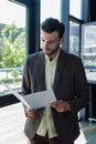 Young businessman in jacket using earphone Royalty Free Stock Photo