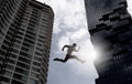 Young businessman jumping high, Work, job, or successful business concept. Cityscape background Royalty Free Stock Photo