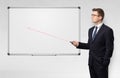 Businessman with laser pointer and copyspace white blackboard Royalty Free Stock Photo