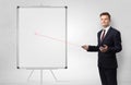 Businessman with laser pointer and copyspace white blackboard Royalty Free Stock Photo