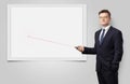 Businessman with laser pointer and copyspace white blackboard Royalty Free Stock Photo