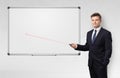 Businessman with laser pointer and copyspace white blackboard Royalty Free Stock Photo