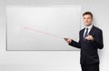 Businessman with laser pointer and copyspace white blackboard Royalty Free Stock Photo