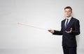 Businessman with laser pointer and copyspace white wall