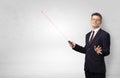 Businessman with laser pointer and copyspace white wall