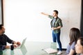 Young man giving presentation to colleagues Royalty Free Stock Photo