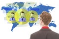 Young businessman looking at blue world map with friends isolated Royalty Free Stock Photo