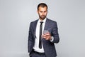 Young handsome businessman looking at his pda mobile phone isolated on white background Royalty Free Stock Photo