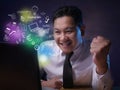 Young Businessman Looking at Laptop, Winning Gesture