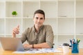 Young businessman looking at market research report Analyze statistical data in charts. Develop a growth strategy Work on a comput Royalty Free Stock Photo