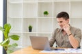 Young businessman looking at market research report Analyze statistical data in charts. Develop a growth strategy Work on a comput Royalty Free Stock Photo