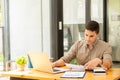 Young businessman looking at market research report Analyze statistical data in charts. Develop a growth strategy Work on a comput Royalty Free Stock Photo