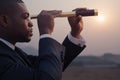 Young businessman looking through telescope in the middle of the desert Royalty Free Stock Photo