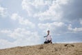 Young businessman lost and walking through the desert, distant Royalty Free Stock Photo