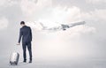 Businessman with luggage walking to airplane