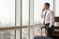 Young businessman making call in hotel room Royalty Free Stock Photo