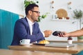 Businessman making contactless card payment in a cafe Royalty Free Stock Photo