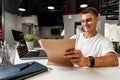 Young businessman making notes at tabletop with laptop in office Royalty Free Stock Photo