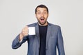 Young businessman man with a beard in a jacket, holding a cup of coffee, scared in shock with a surprised face, scared and excited Royalty Free Stock Photo