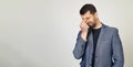 Young businessman man with a beard in a jacket, tired of rubbing his nose and eyes, feeling tired and headache. Stress and Royalty Free Stock Photo