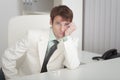 Young businessman misses on workplace at office Royalty Free Stock Photo