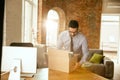 A young businessman moving in office, getting new work place