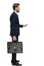 Young businessman in navy blue suit holding suitcase and standing in line Royalty Free Stock Photo