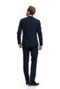 Young businessman in navy blue suit looking up and dreaming