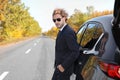 Young businessman near modern car on sunny day