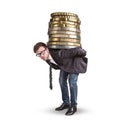 Businessman carrying a giant stack of coins on his back