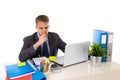 Young businessman overworked looking worried sitting at office computer desk in stress Royalty Free Stock Photo