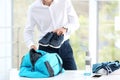 Young businessman packing sports stuff for training Royalty Free Stock Photo