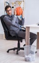 Young businessman playing basketball in office during break Royalty Free Stock Photo