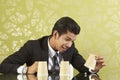 Young businessman playing the shell game. Conceptual image