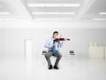 young businessman playing violin Royalty Free Stock Photo