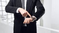 Young businessman point a finger on the watch Royalty Free Stock Photo