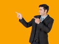 A young businessman pointing both finger in the same direction Royalty Free Stock Photo