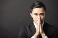 Young businessman with pray gesture