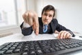 Young businessman is pressing enter key on keyboard and submitting a form Royalty Free Stock Photo