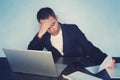 Young businessman with a problem at office sitting at his desk with his hands to his temples frowning at his computer screen, tire Royalty Free Stock Photo