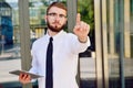 A young businessman pushes his index finger against a virtual screen